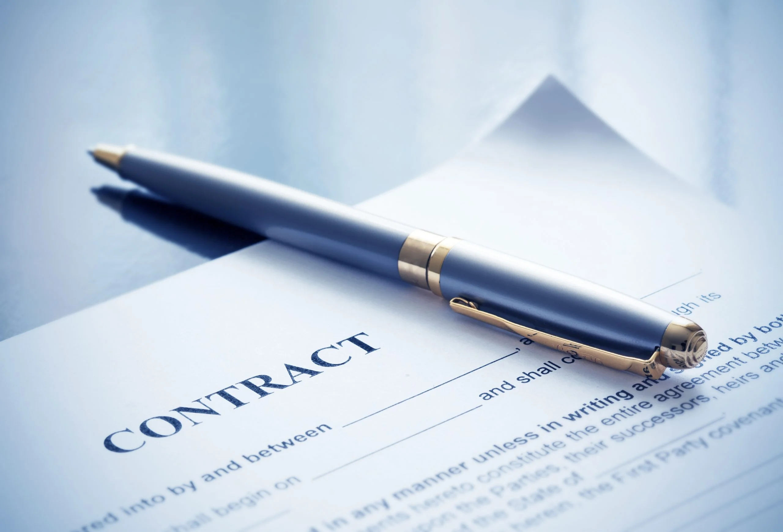 Image shows legal contract and pen contract lawyer uk